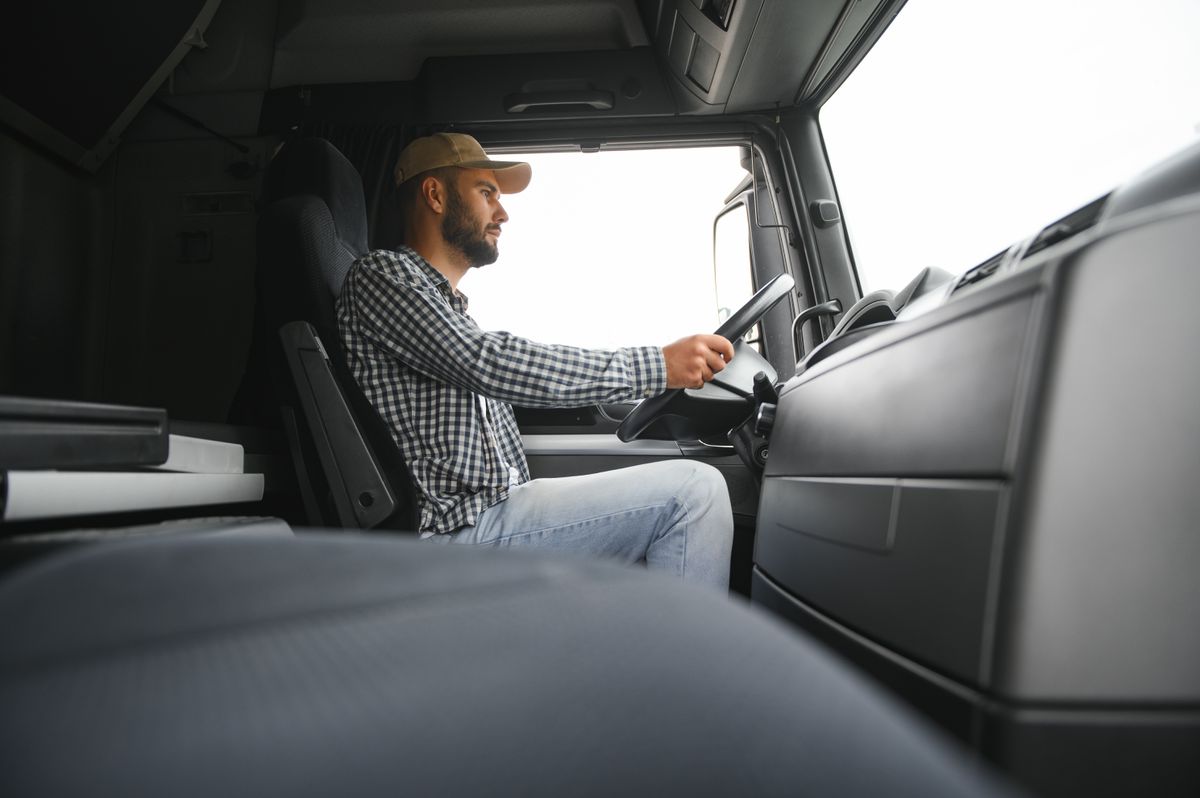 Driver,Behind,The,Wheel,In,Truck,Cabin